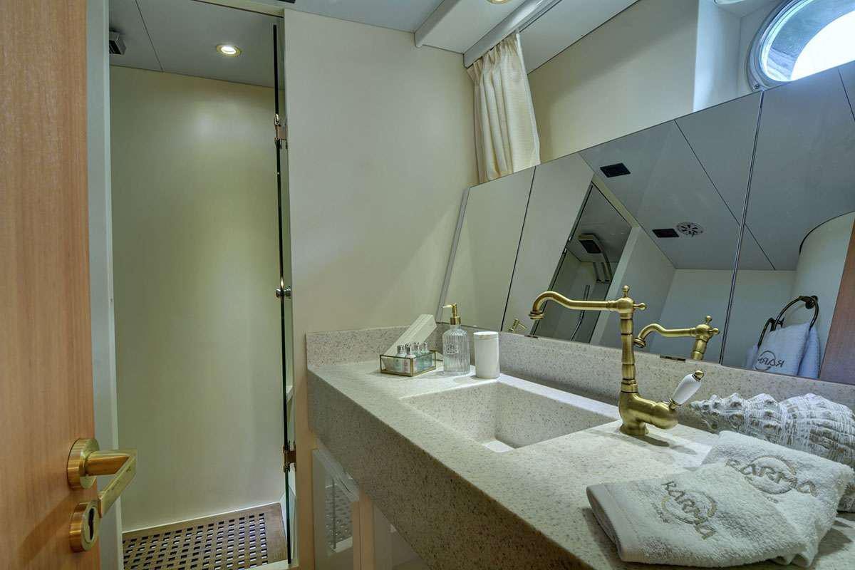 a bathroom with a sink and a mirror aboard KARMA Yacht for Charter
