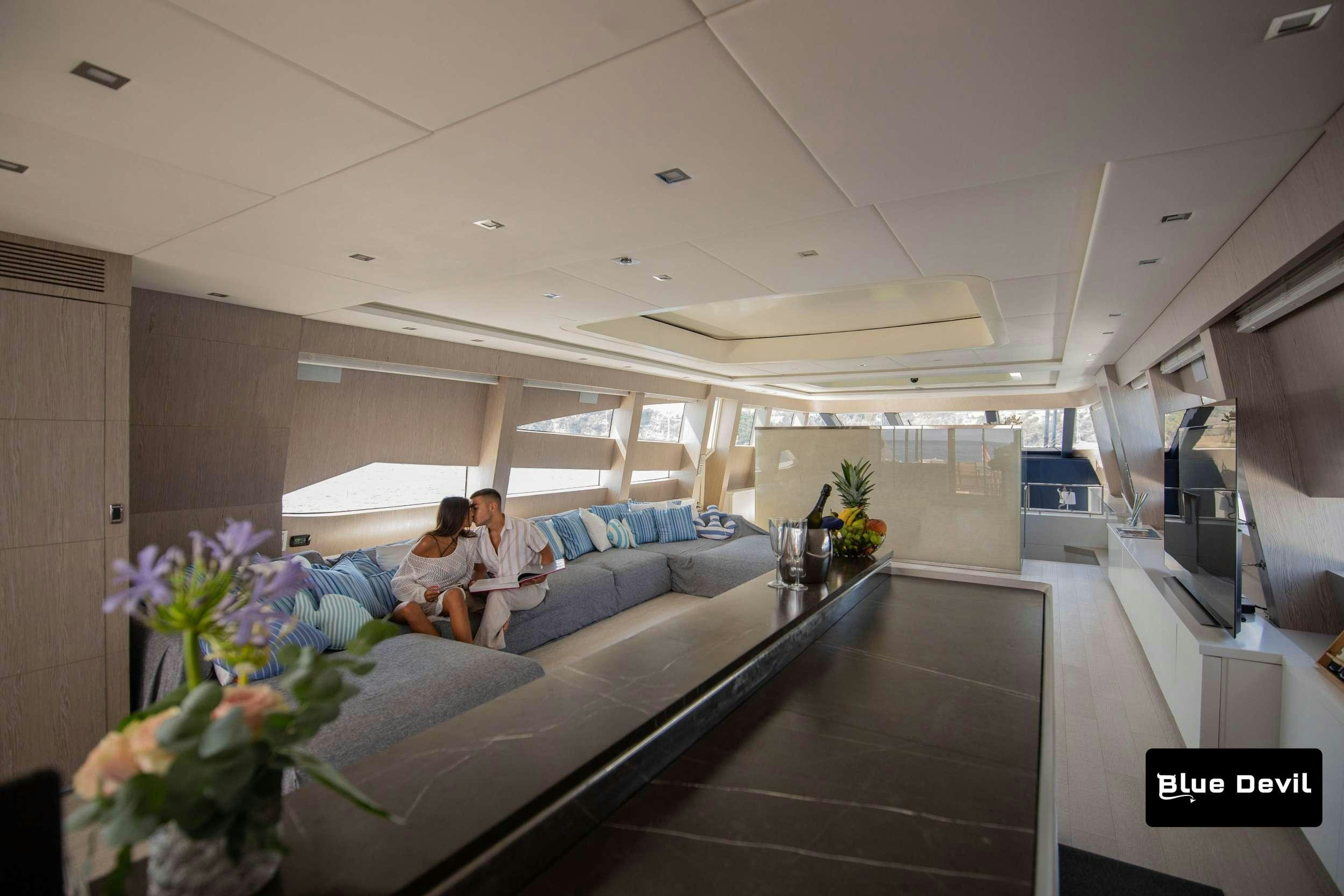 a couple sitting on a couch aboard BLUE DEVIL Yacht for Charter