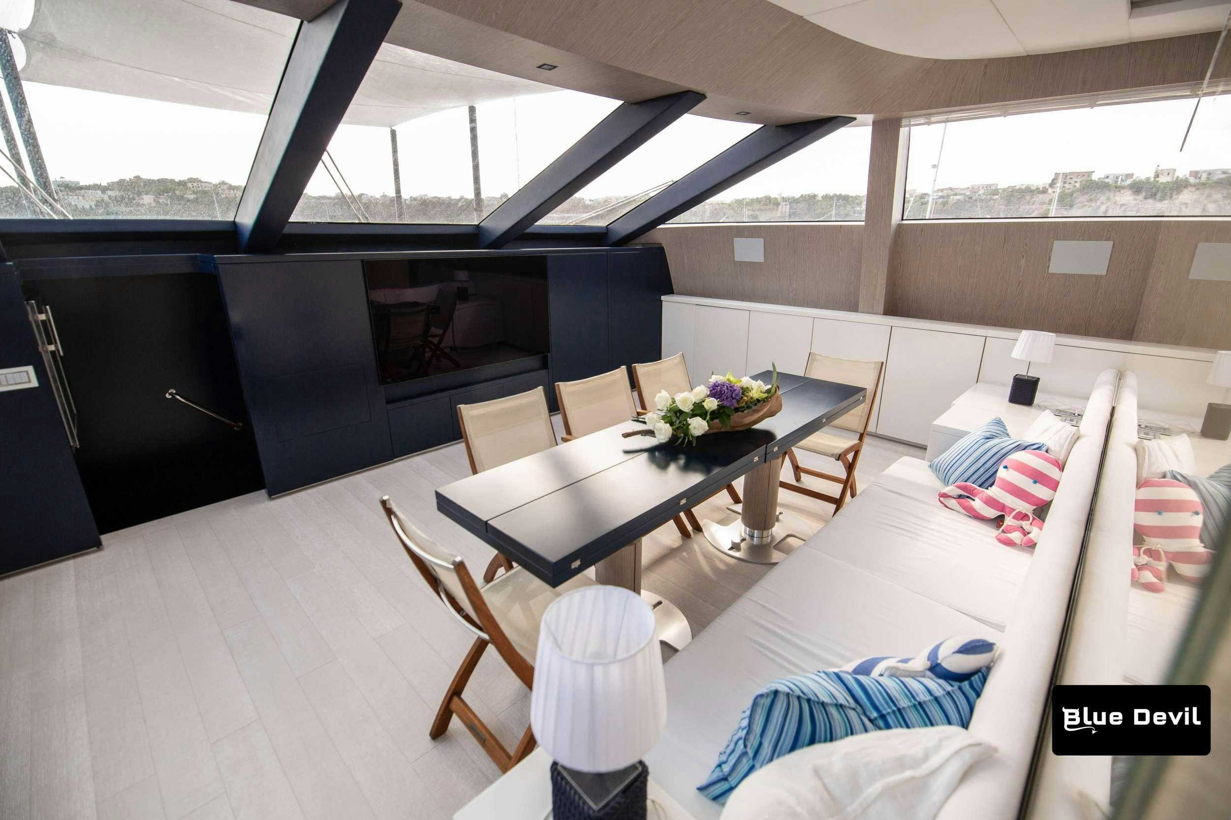 a room with a table and chairs aboard BLUE DEVIL Yacht for Charter