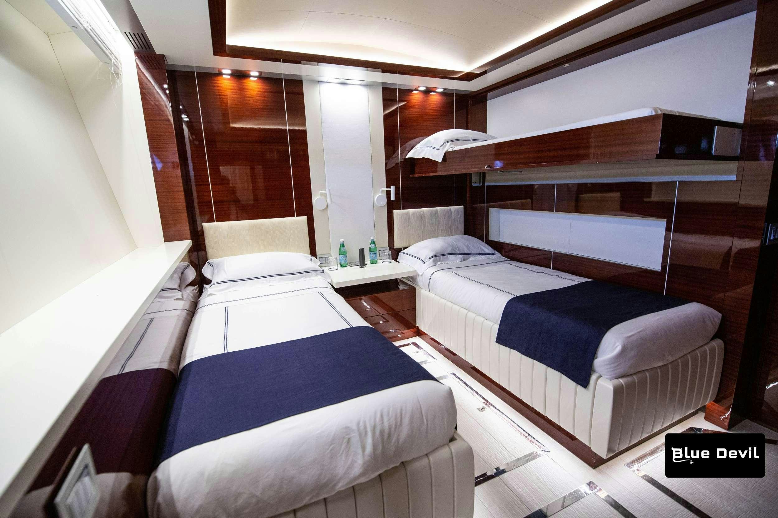 a room with beds and a window aboard BLUE DEVIL Yacht for Charter