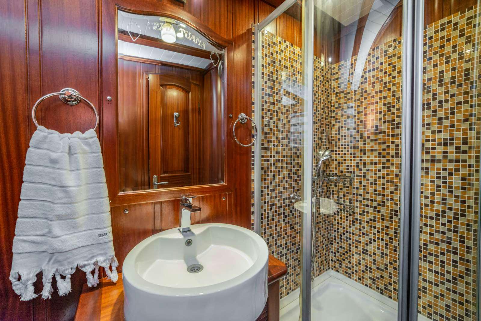 a bathroom with a sink and a mirror aboard SEMA TUANA Yacht for Charter