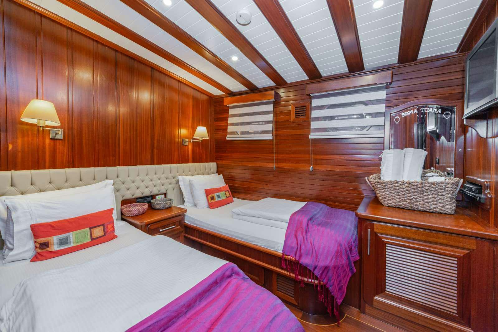 a couple of beds in a room aboard SEMA TUANA Yacht for Charter