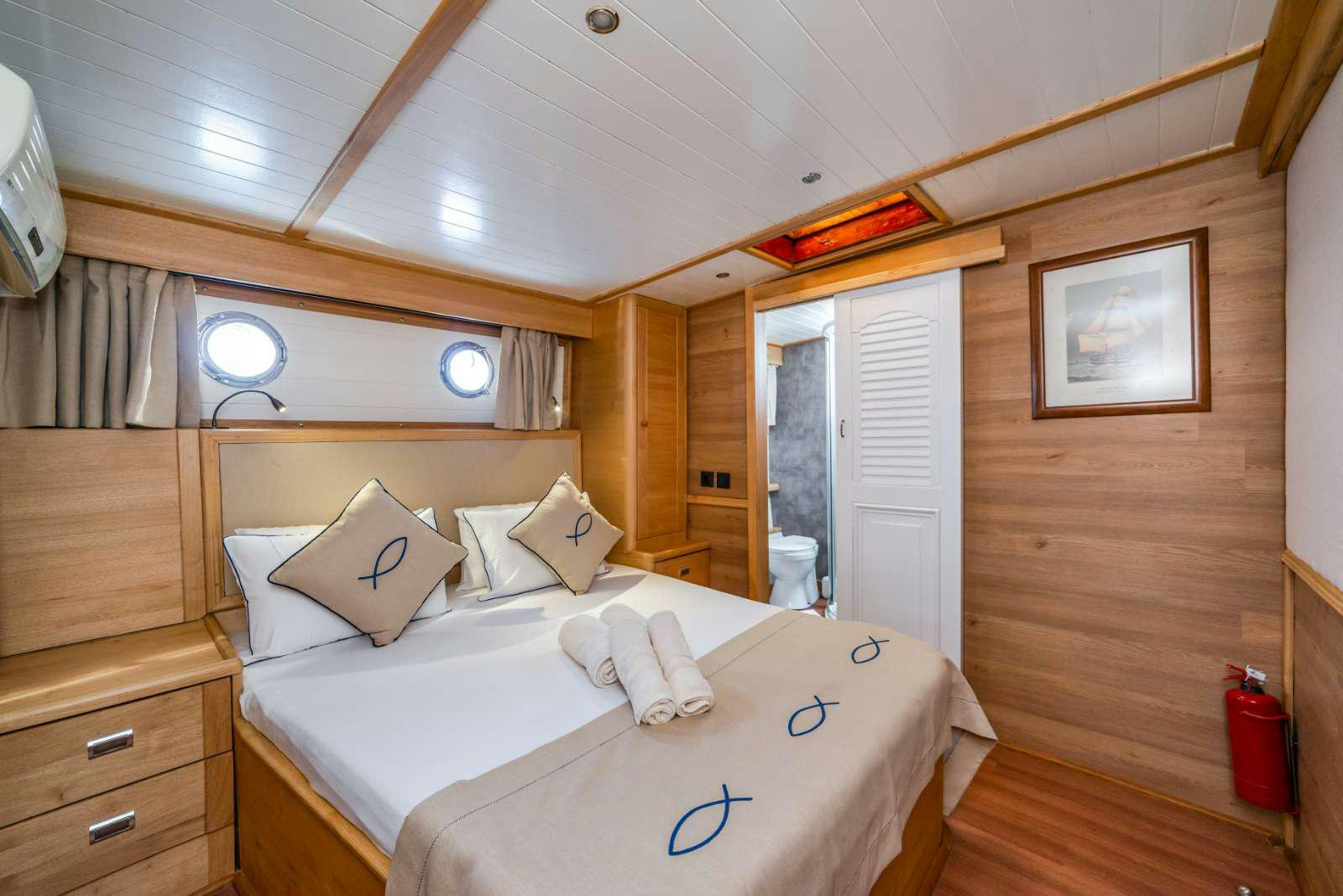 a room with a bed and a mirror aboard AMAZON SOLO Yacht for Charter