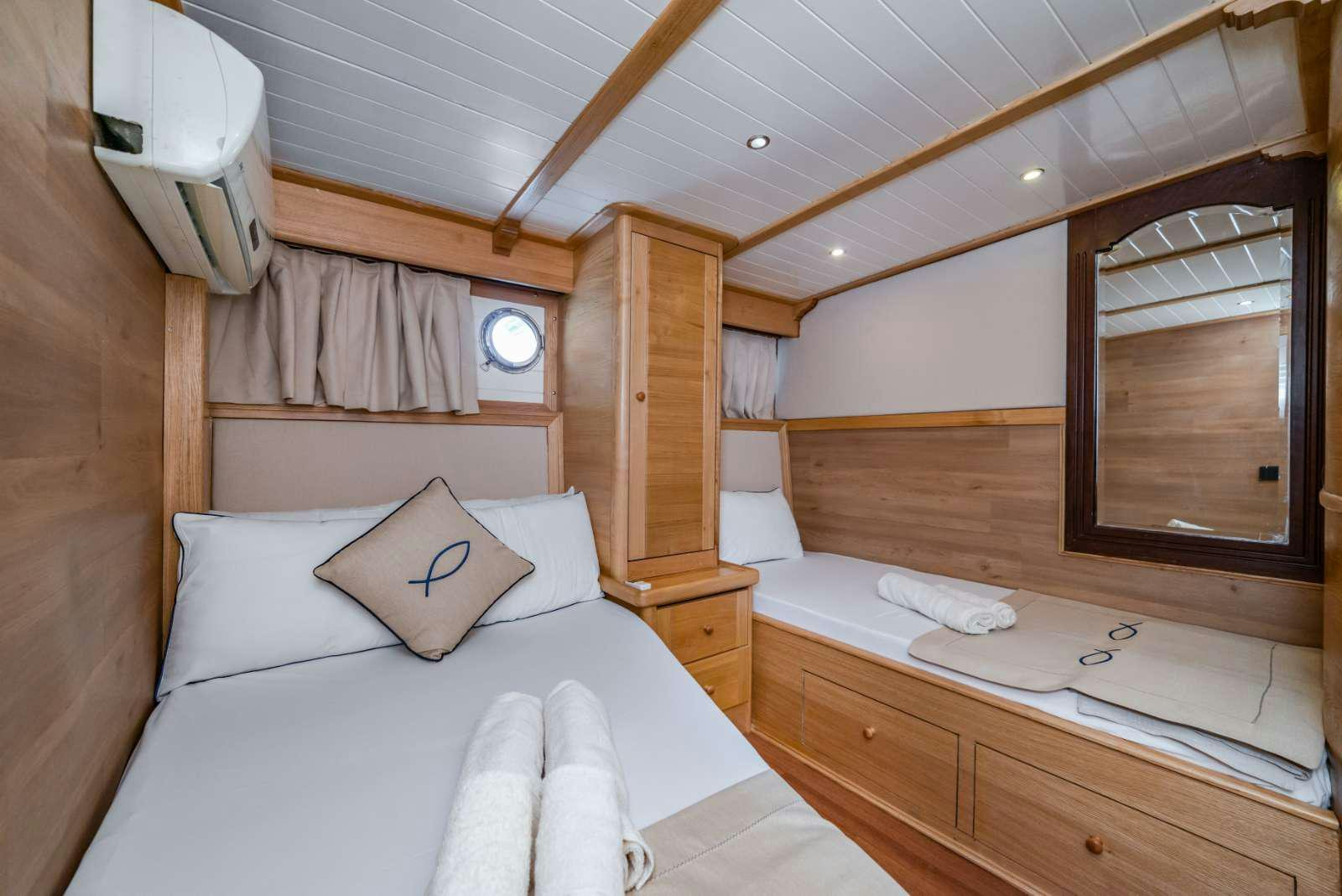 a room with a bed and a mirror aboard AMAZON SOLO Yacht for Charter
