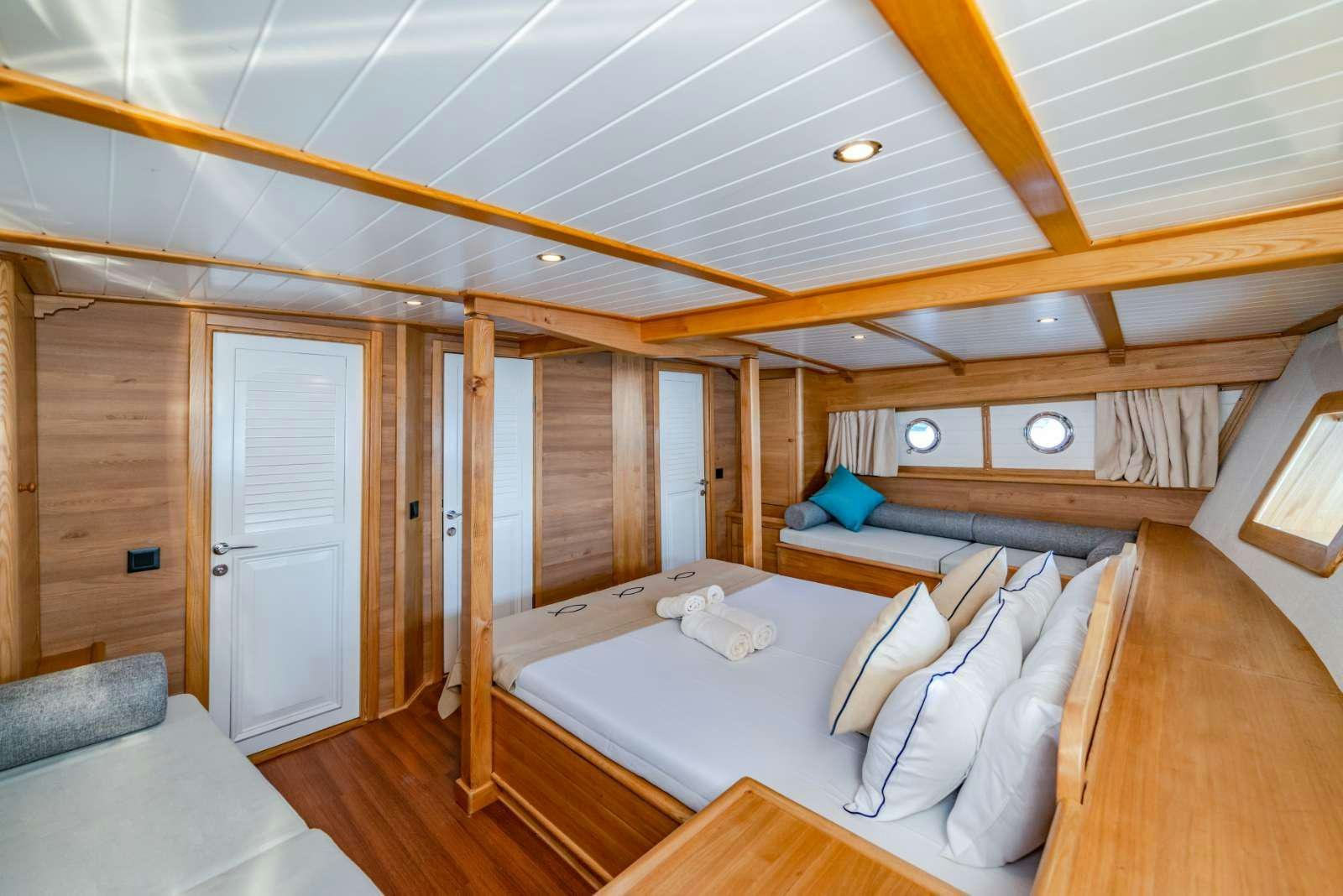 a room with a bed and a wood wall aboard AMAZON SOLO Yacht for Charter