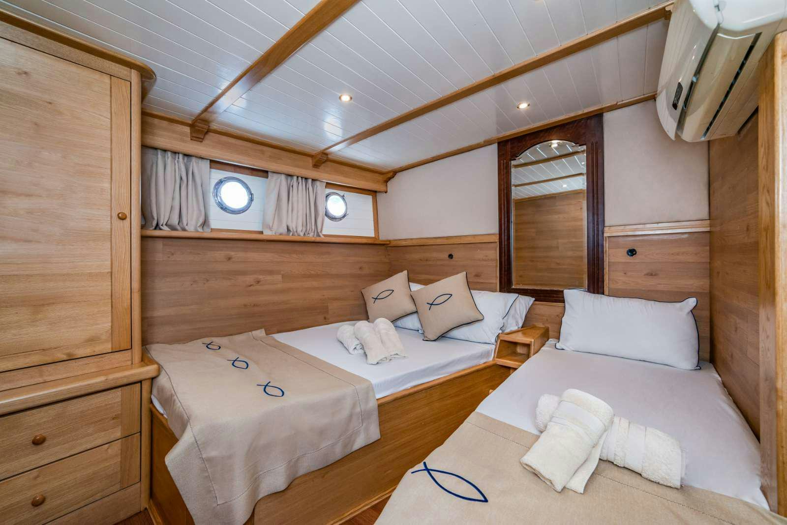 a couple of beds in a cabin aboard AMAZON SOLO Yacht for Charter