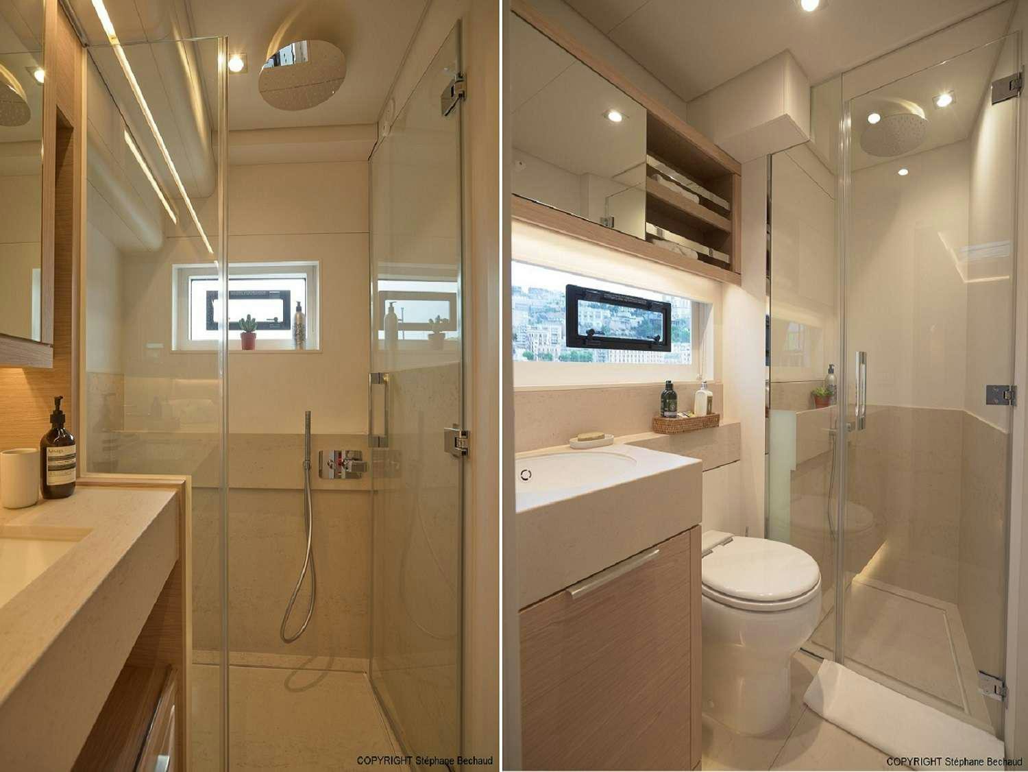 a bathroom with a glass shower aboard KAJIKIA Yacht for Charter