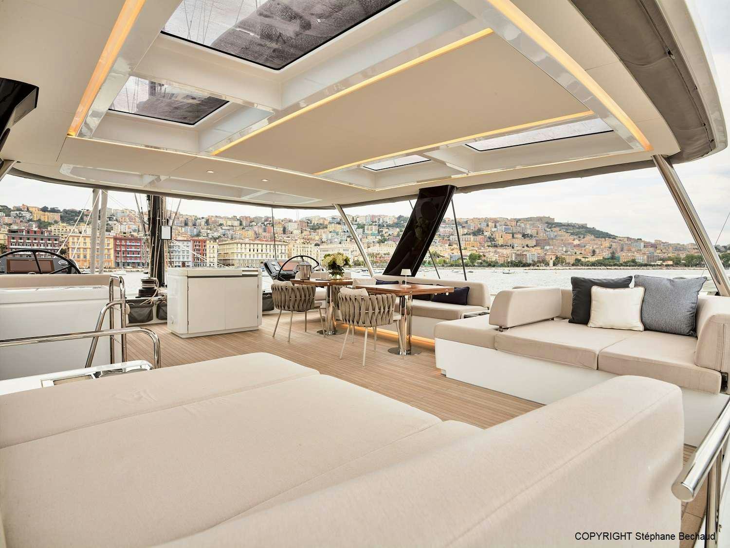 a room with a couch and a table and chairs aboard KAJIKIA Yacht for Charter