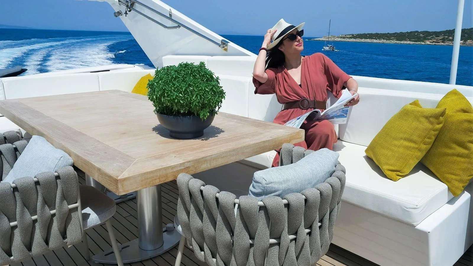 a person sitting at a table on a boat aboard MILGAUSS Yacht for Charter