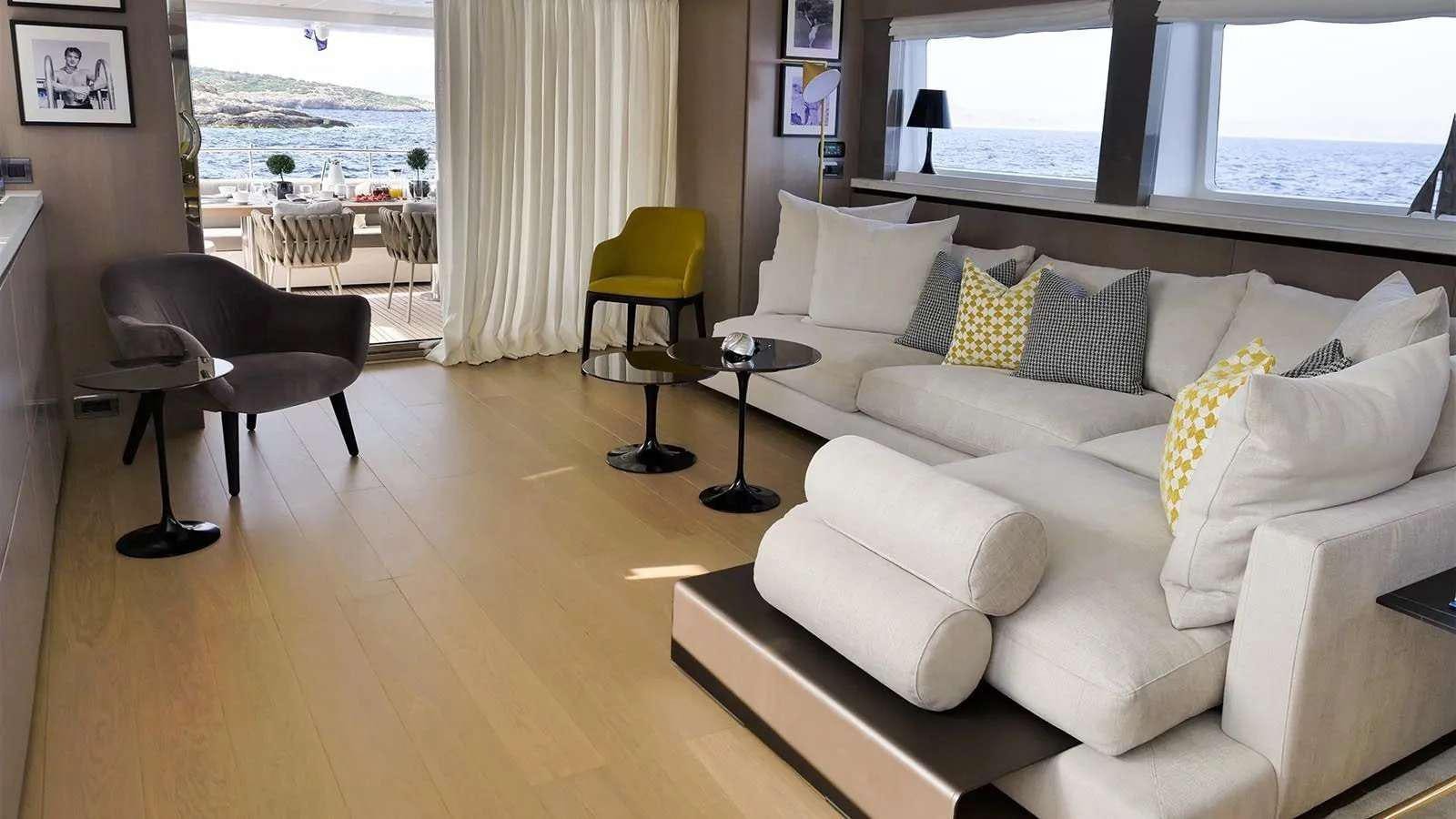 a living room with a couch and a chair aboard MILGAUSS Yacht for Charter
