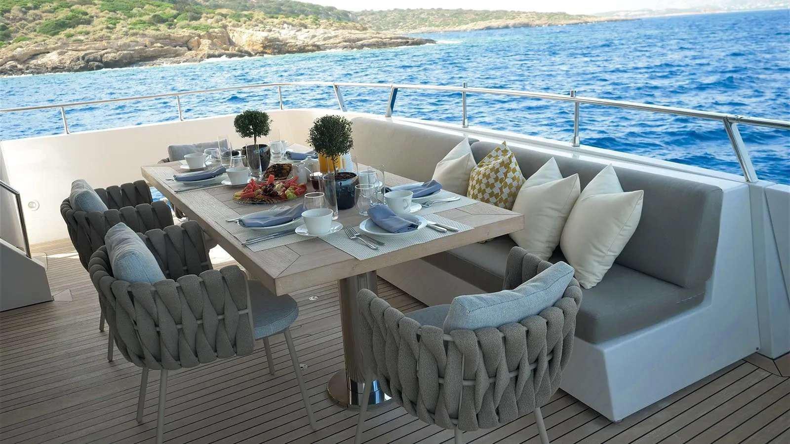 a table with chairs on it aboard MILGAUSS Yacht for Charter