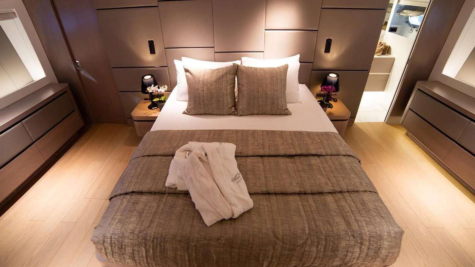 a bed with white sheets aboard MILGAUSS Yacht for Charter