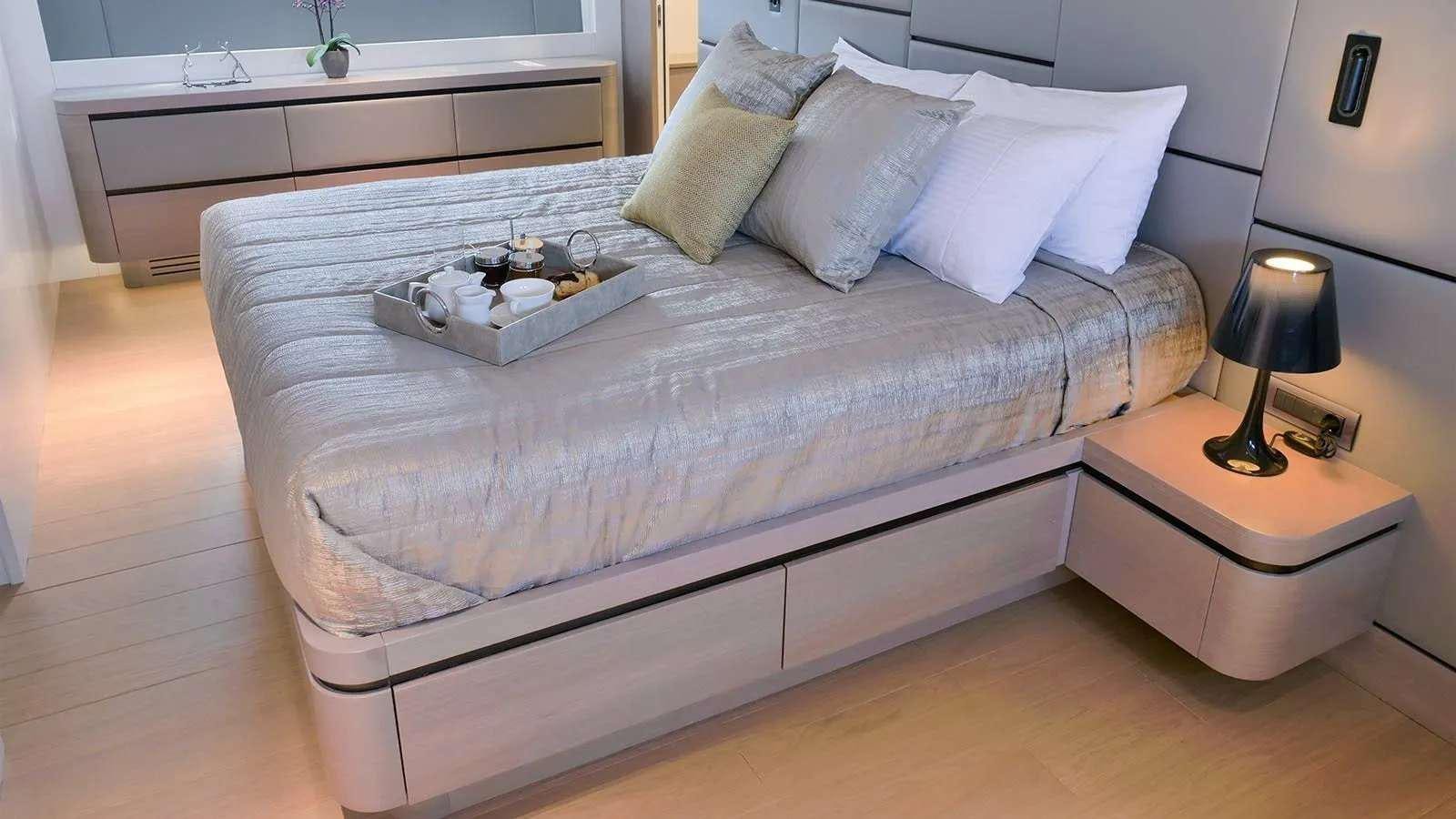 a bed with a tray on it aboard MILGAUSS Yacht for Charter