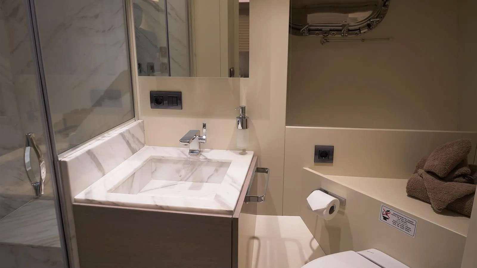 a bathroom with a sink and mirror aboard MILGAUSS Yacht for Charter