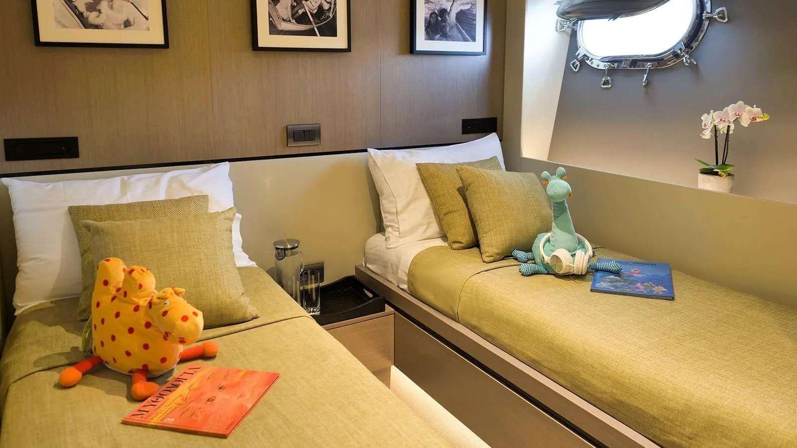 a bedroom with a bed and a stuffed toy aboard MILGAUSS Yacht for Charter