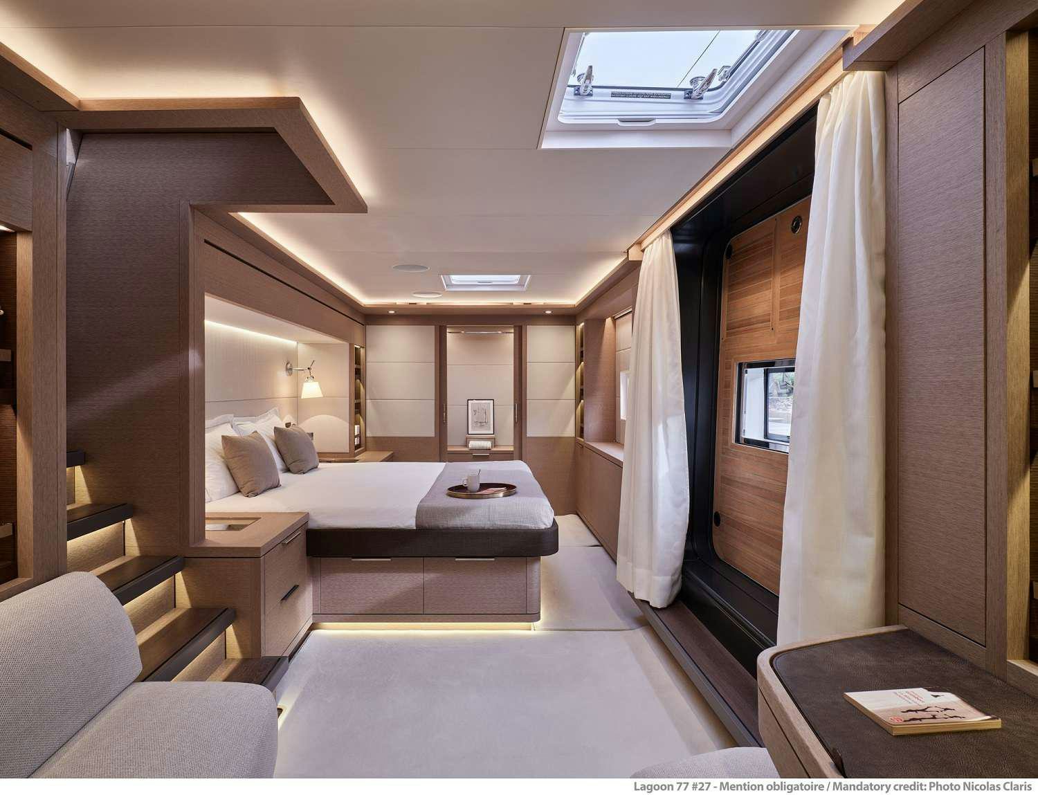 a room with a bed and a desk aboard SYLENE Yacht for Charter