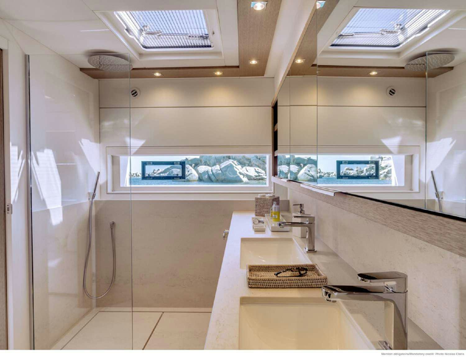 a kitchen with a countertop sink and a large mirror aboard SYLENE Yacht for Charter