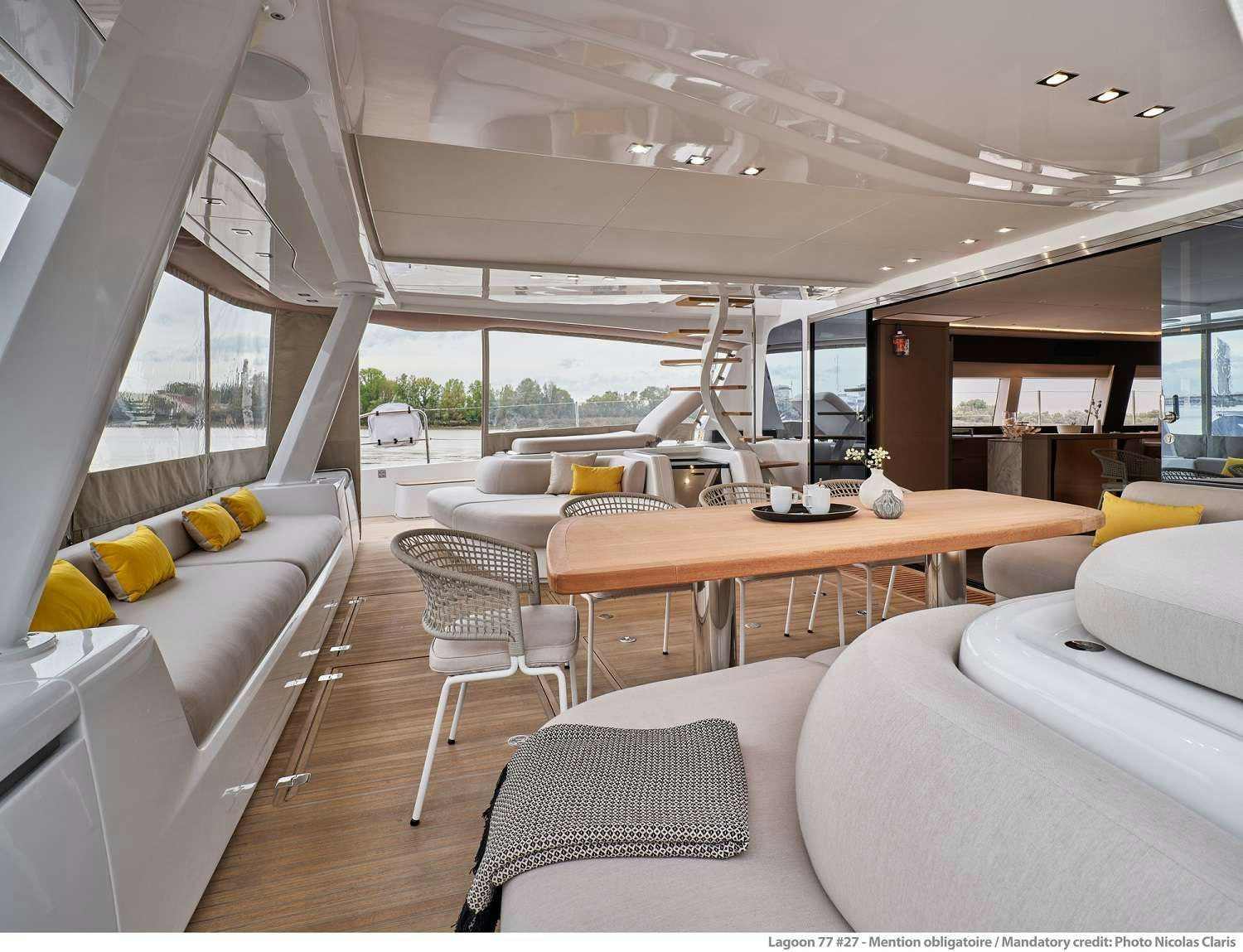 a room with a table chairs and a couch aboard SYLENE Yacht for Charter