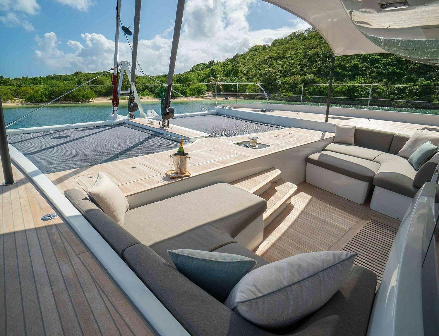 a deck with a view of a lake and a boat aboard SYLENE Yacht for Charter