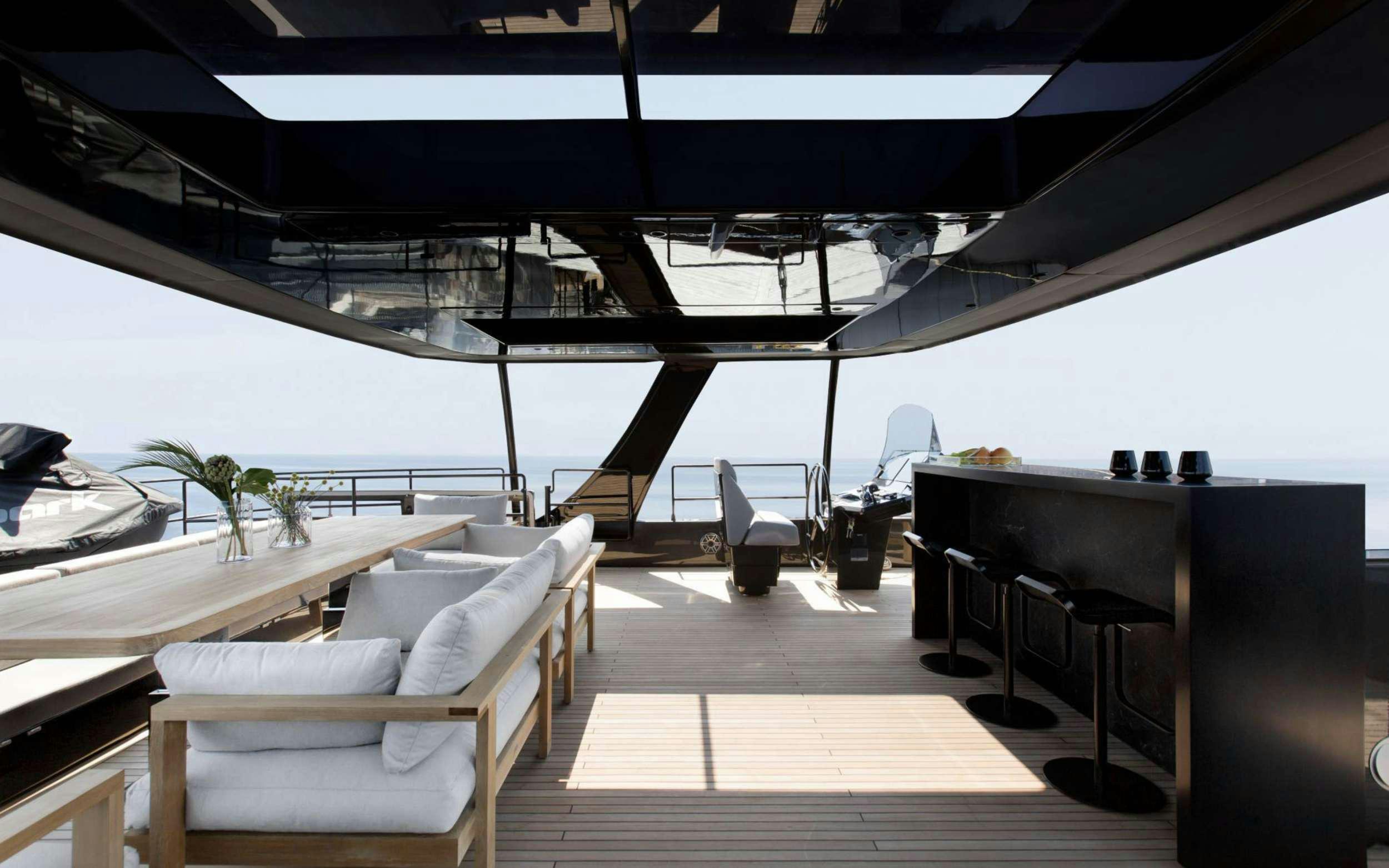 a deck with a pool and lounge chairs on it aboard GRAYONE Yacht for Charter