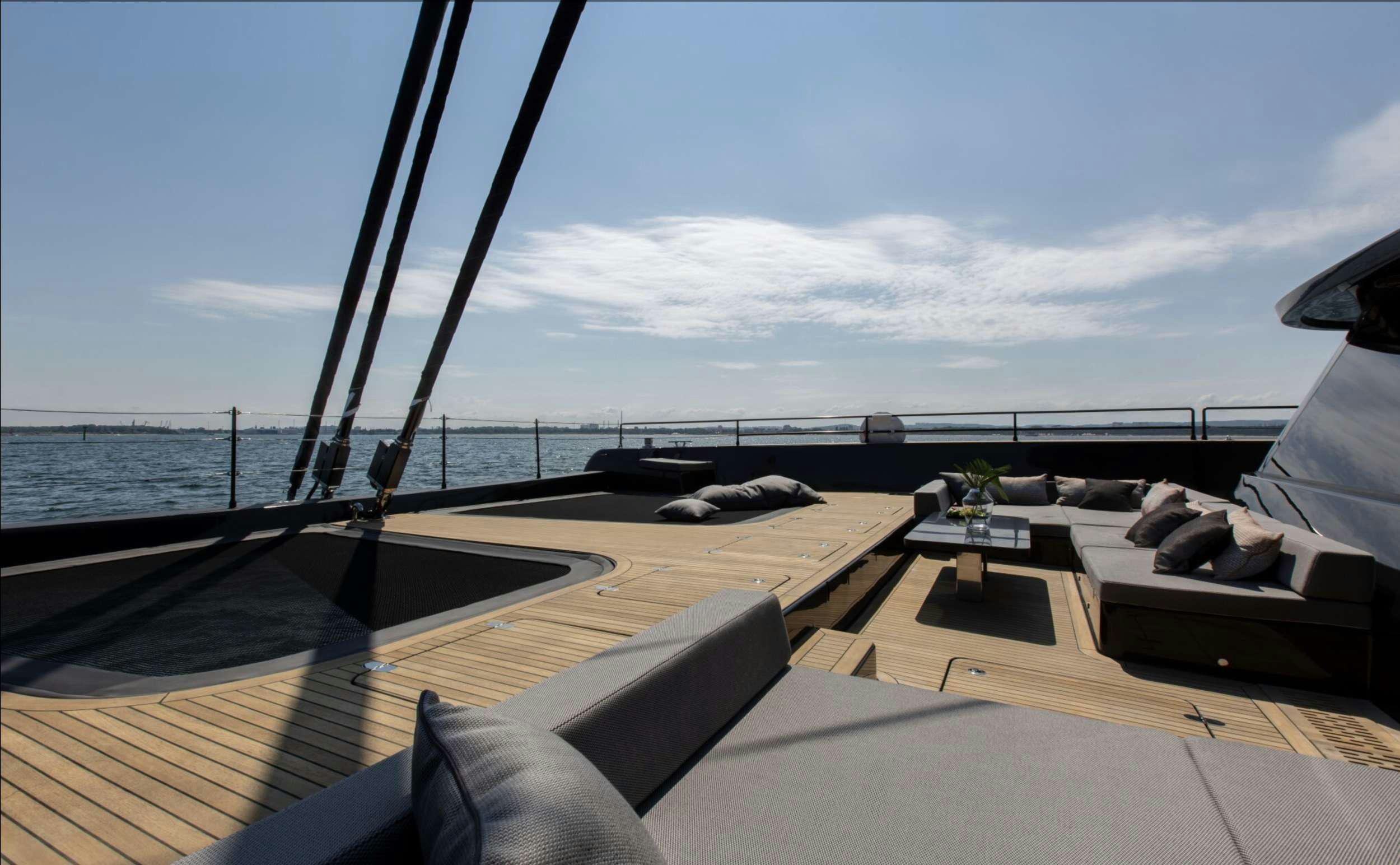 a deck with a view of the ocean and the ocean aboard GRAYONE Yacht for Charter