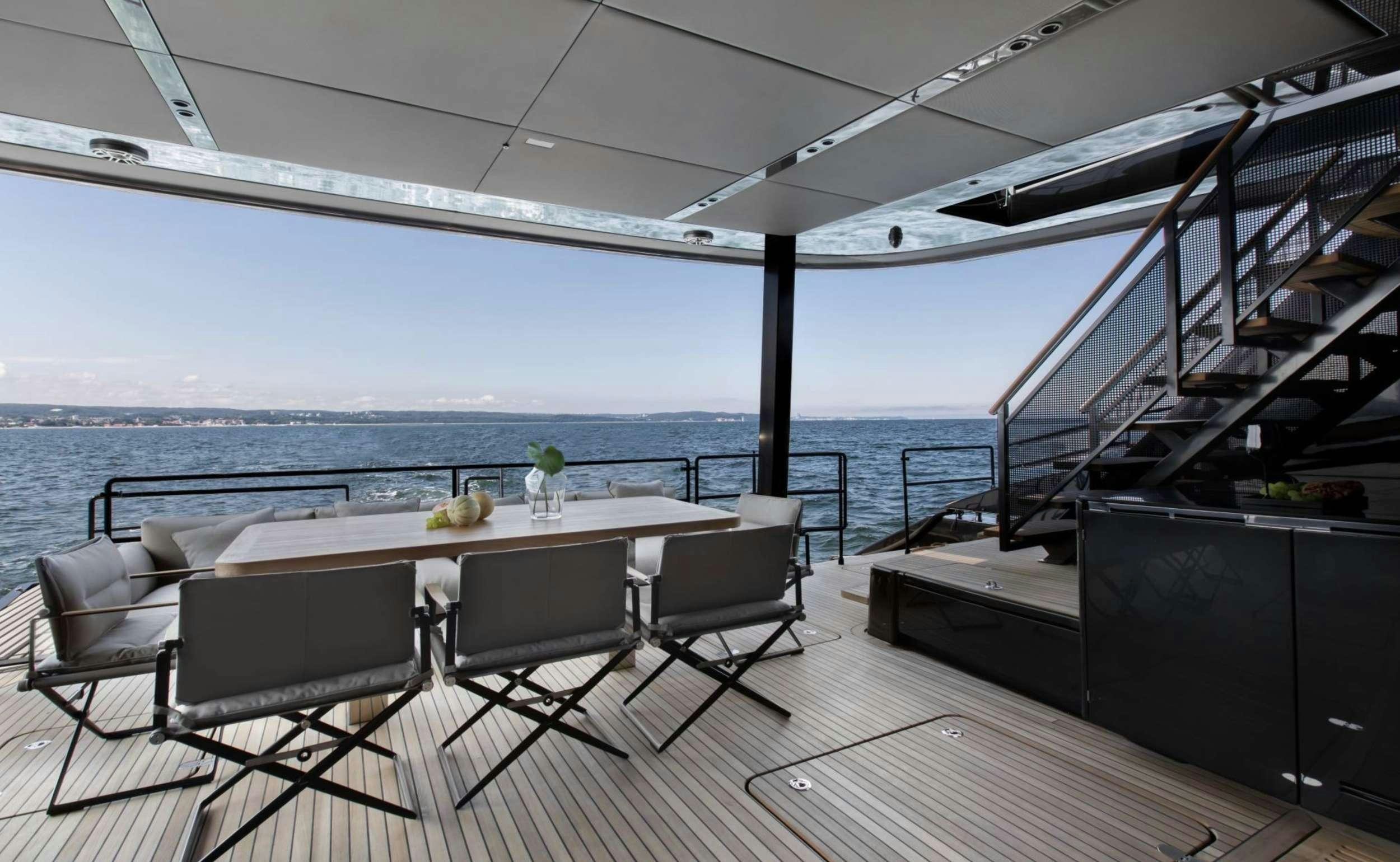 a table and chairs on a deck aboard GRAYONE Yacht for Charter