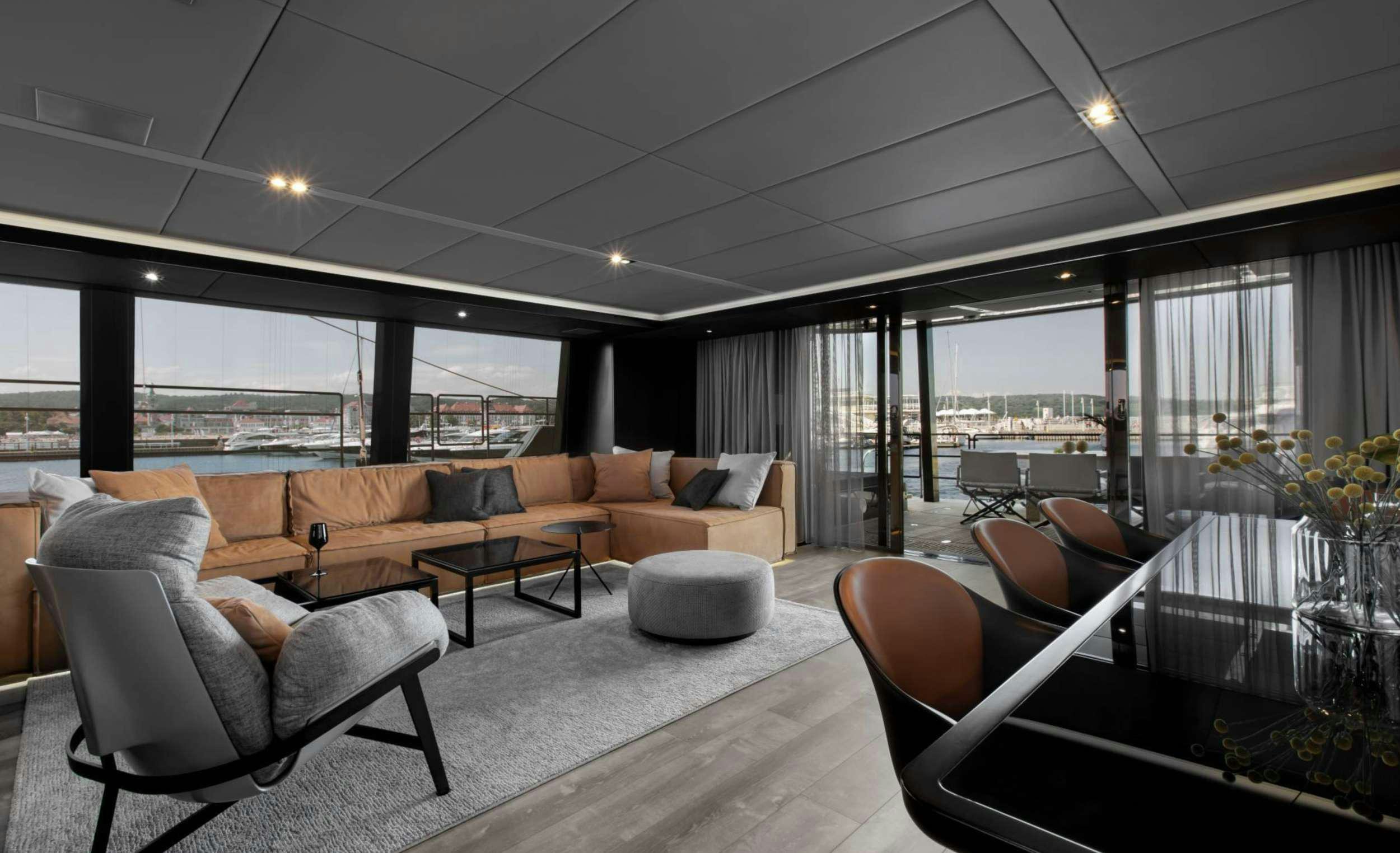 a living room with a large window aboard GRAYONE Yacht for Charter