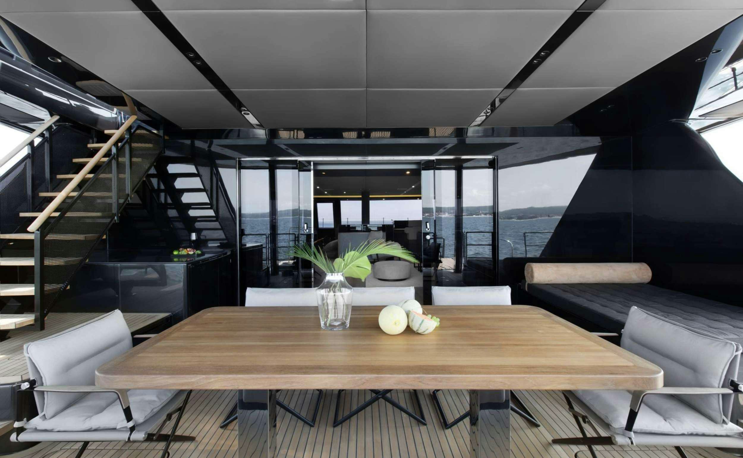 a room with a table and chairs aboard GRAYONE Yacht for Charter
