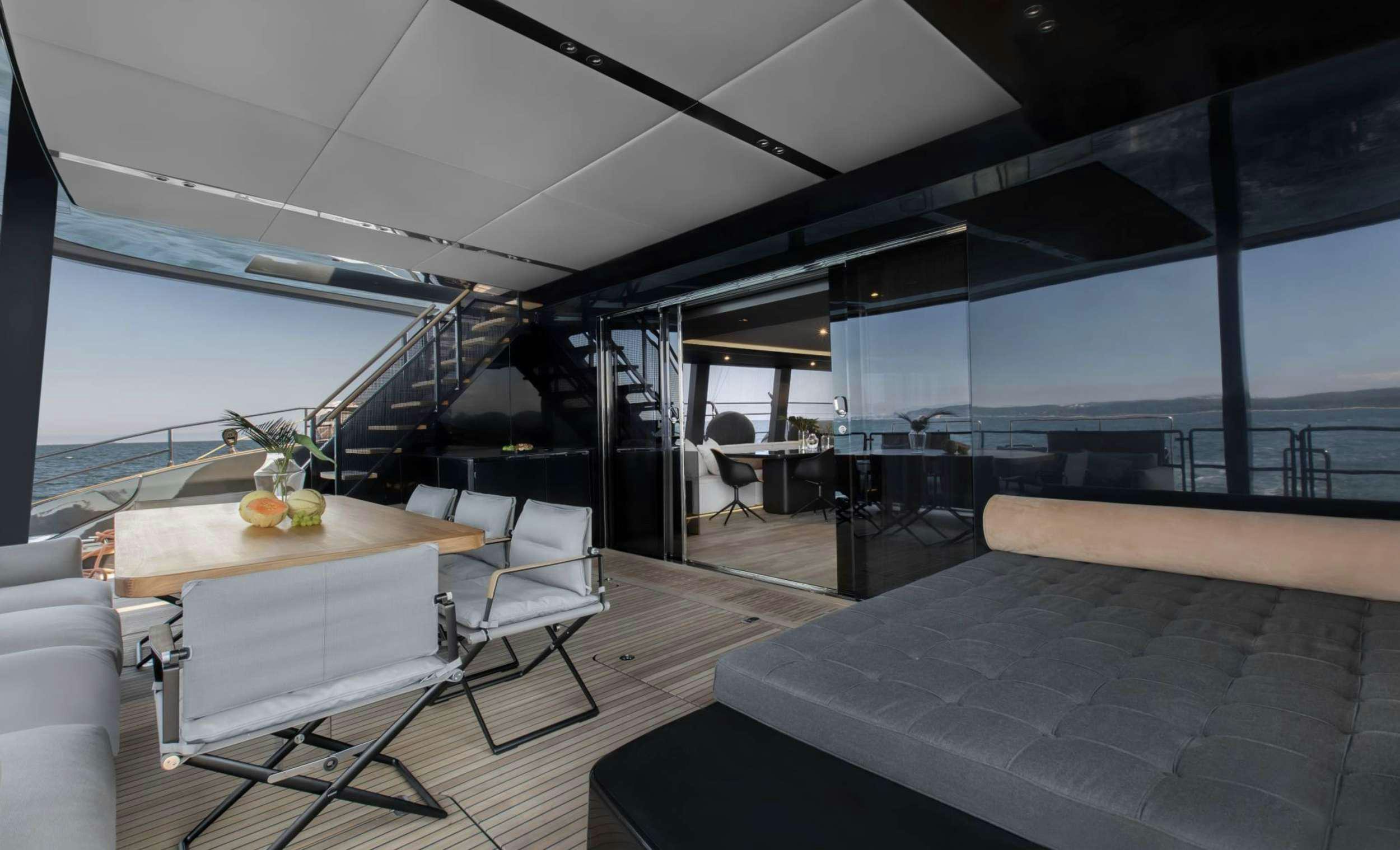a room with a table and chairs aboard GRAYONE Yacht for Charter