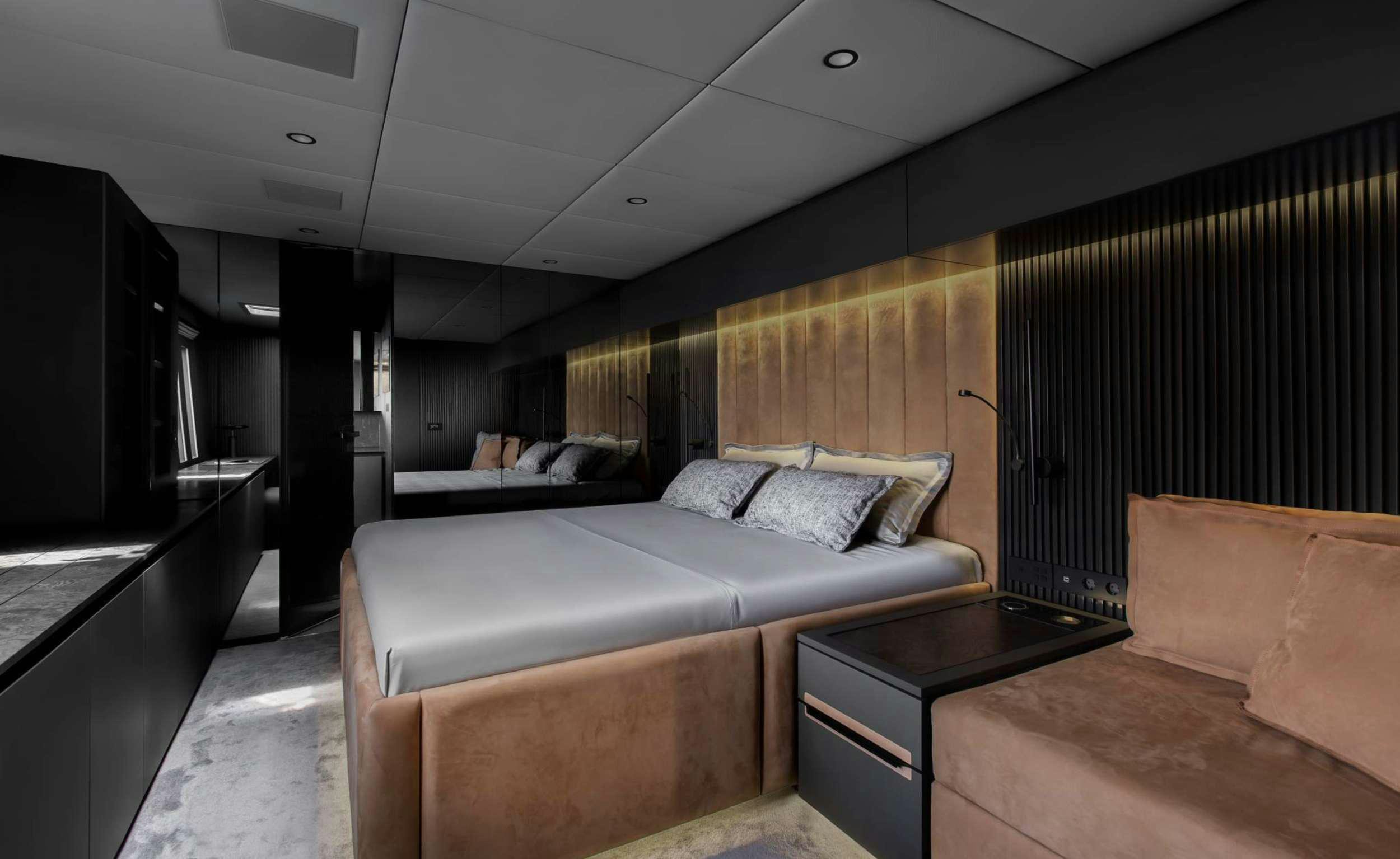 a room with a couch and a tv aboard GRAYONE Yacht for Charter