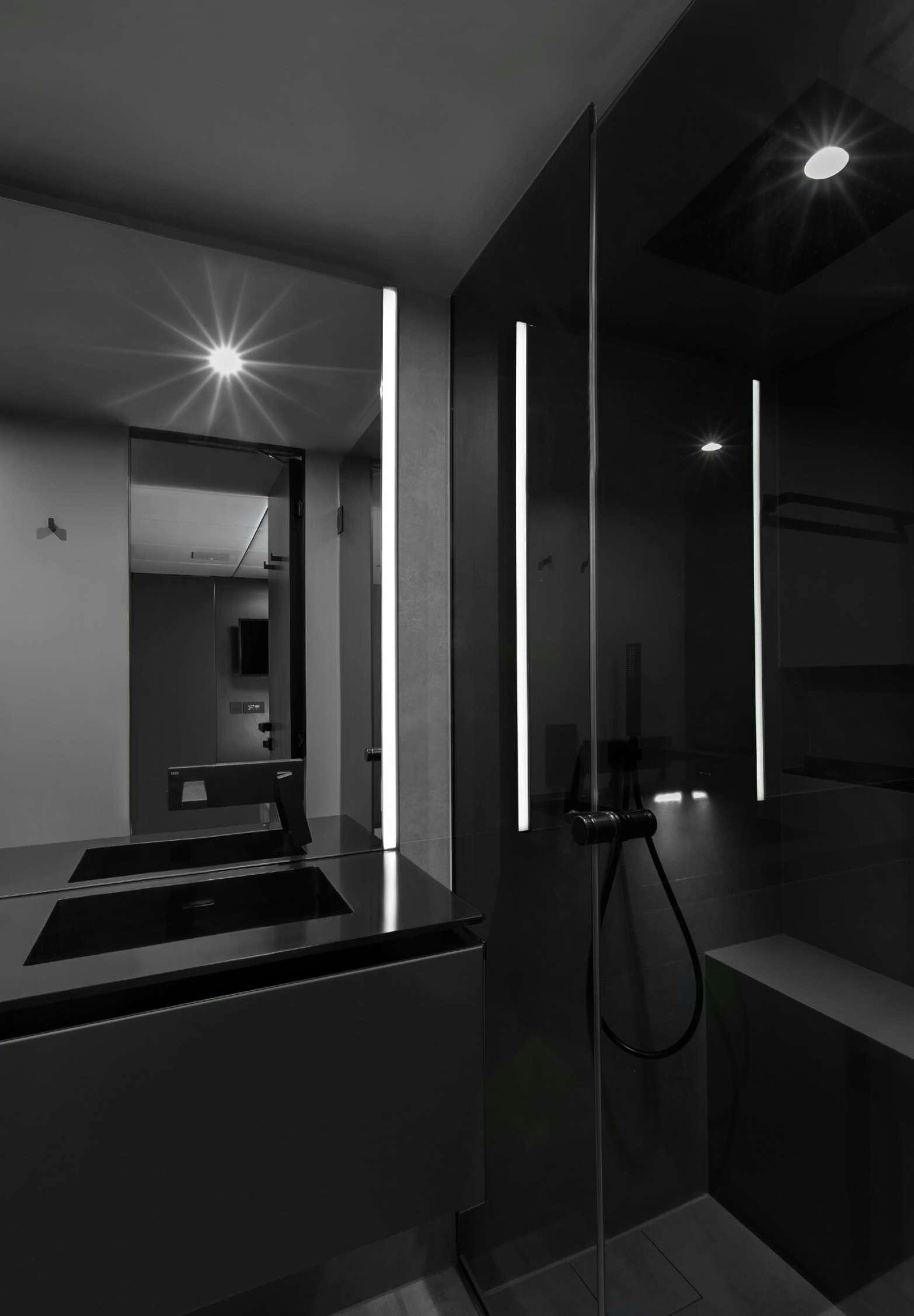 a bathroom with a shower unit and sinks aboard GRAYONE Yacht for Charter