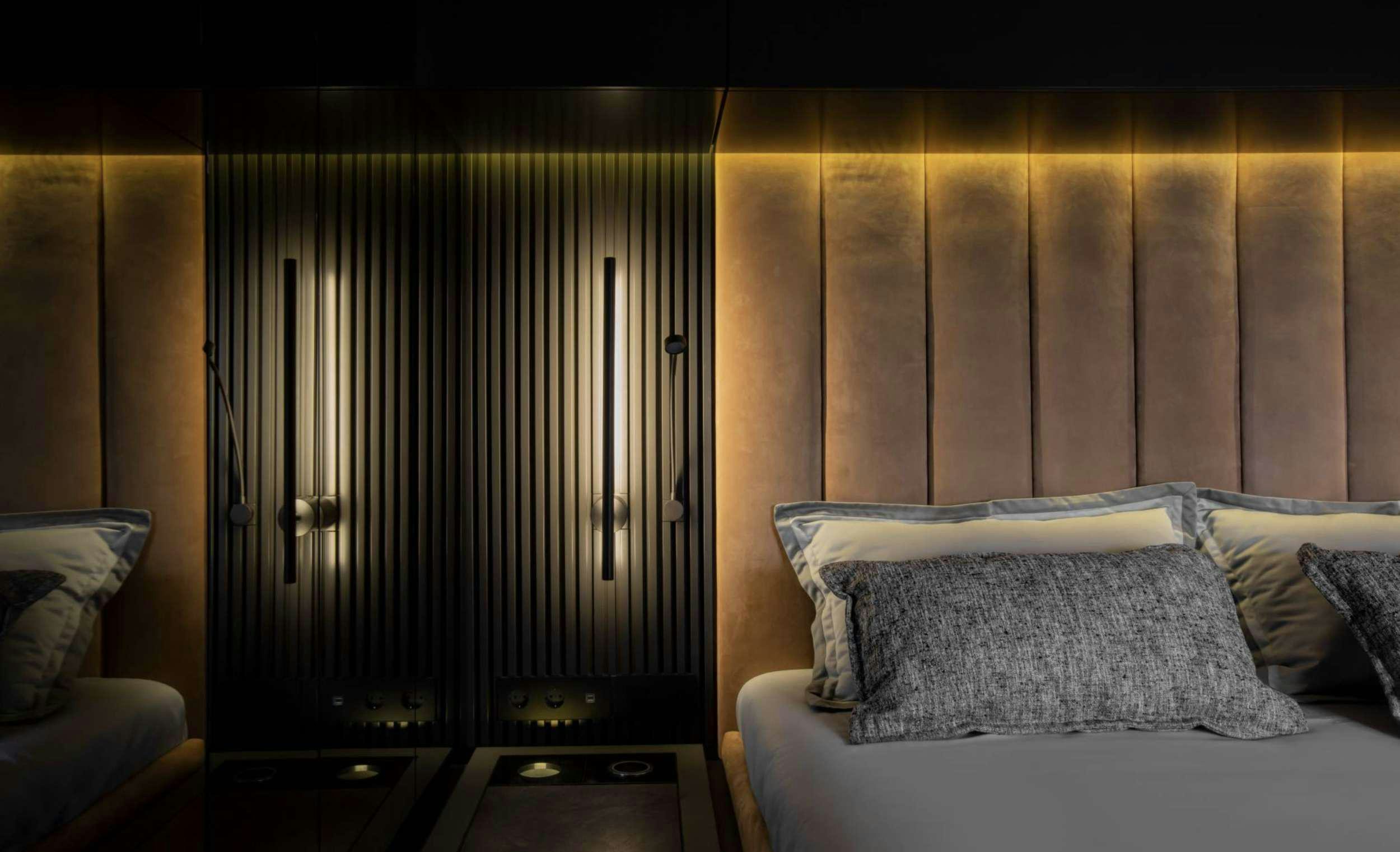 a bed with a pillow and a window aboard GRAYONE Yacht for Charter