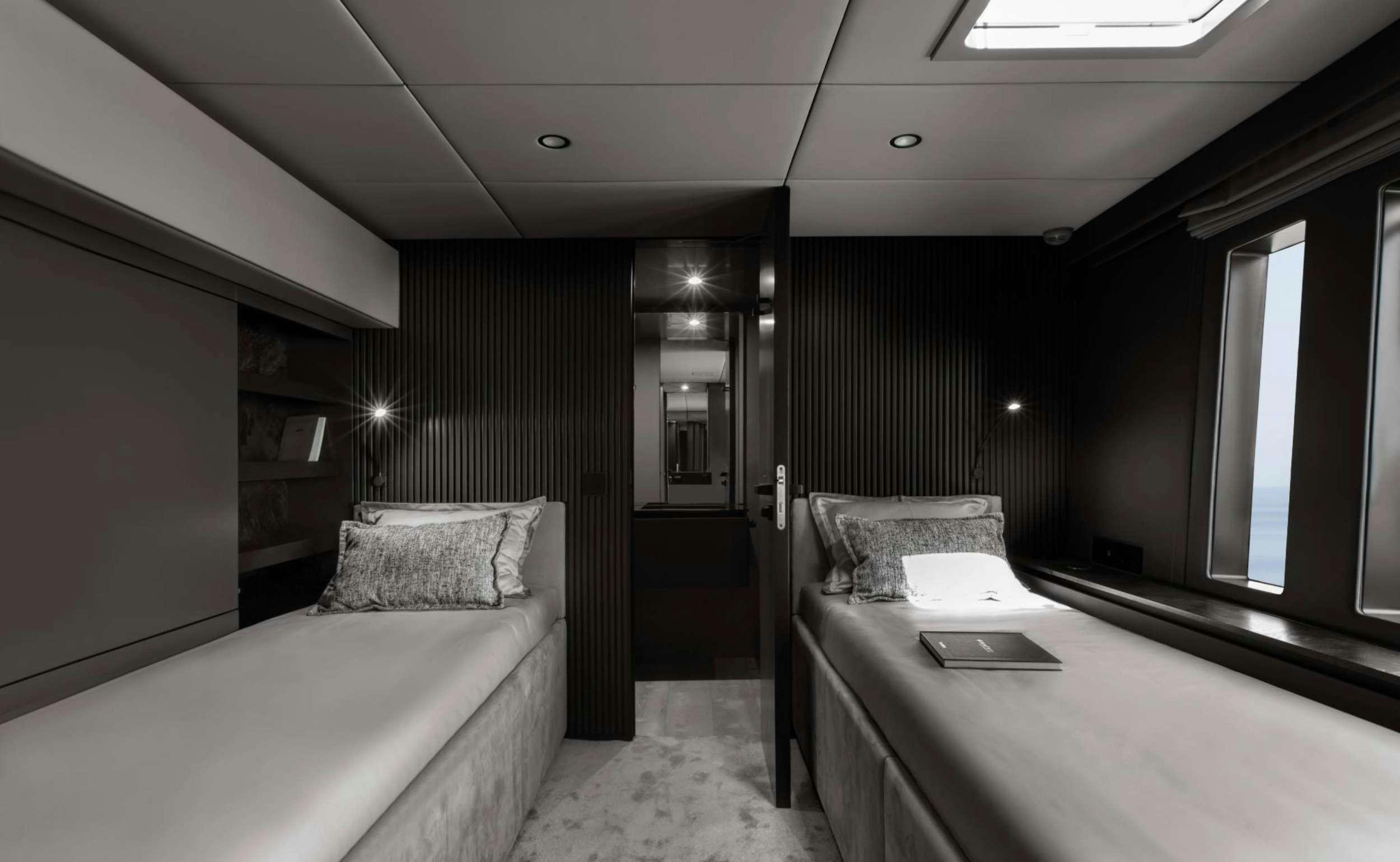 a room with a bed and a laptop on the bed aboard GRAYONE Yacht for Charter