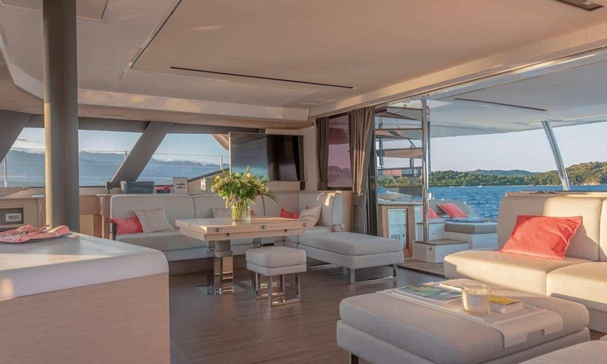 a living room with a large window aboard INDULGENCE Yacht for Charter