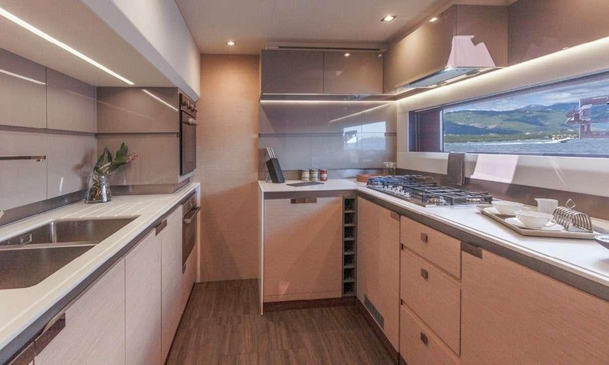 a kitchen with a large window aboard INDULGENCE Yacht for Charter