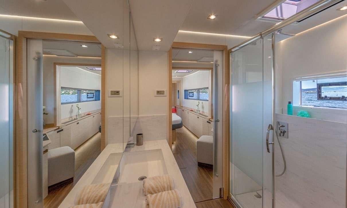 a long hallway with glass doors aboard INDULGENCE Yacht for Charter