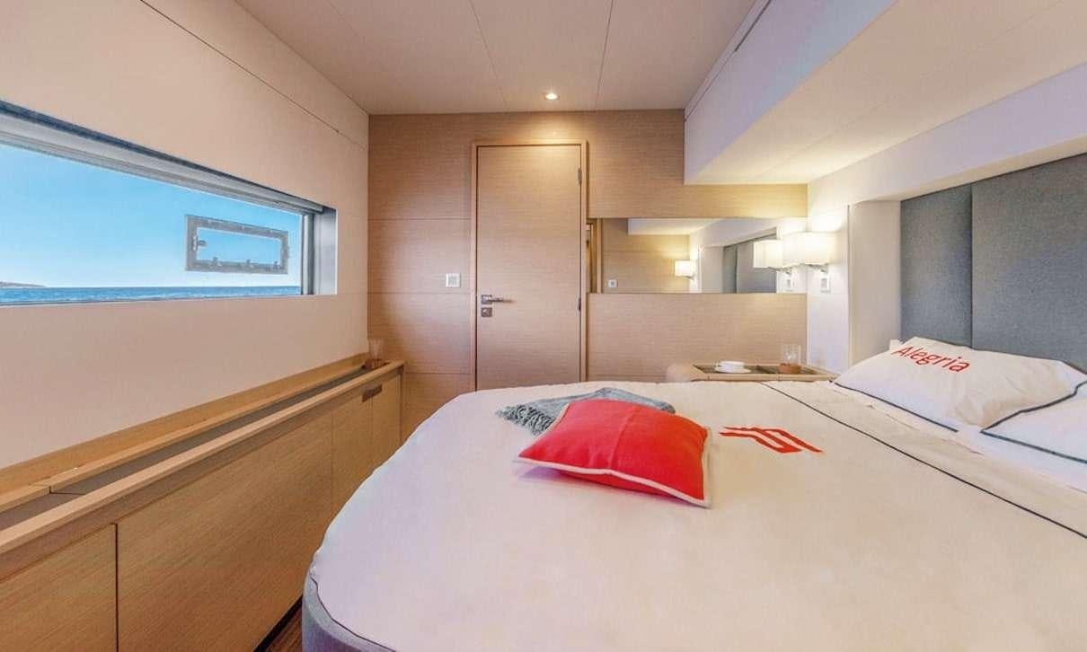 a hotel room with a bed aboard INDULGENCE Yacht for Charter