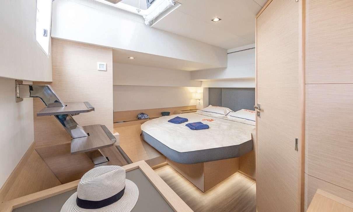 a room with a bed and a hat aboard INDULGENCE Yacht for Charter