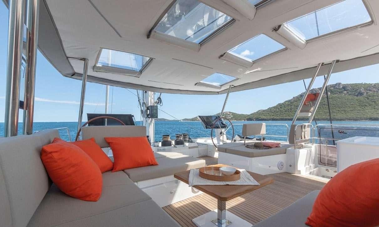 a boat with pillows and a table aboard INDULGENCE Yacht for Charter