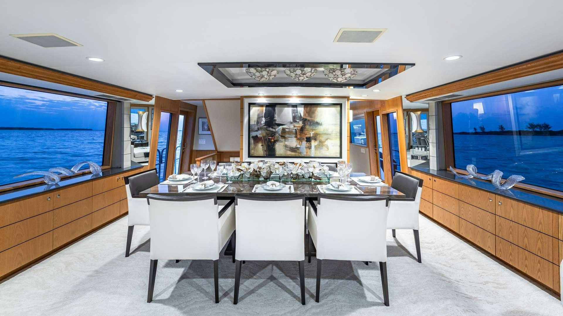 a large room with a table and chairs aboard WHITE PEARL Yacht for Charter