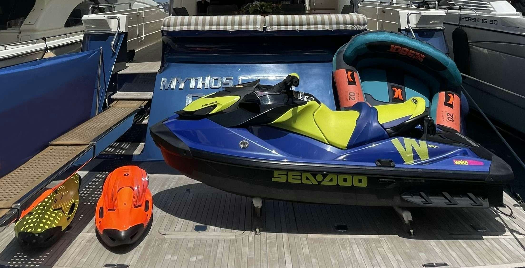 a blue and yellow race car aboard MYTHOS Yacht for Charter