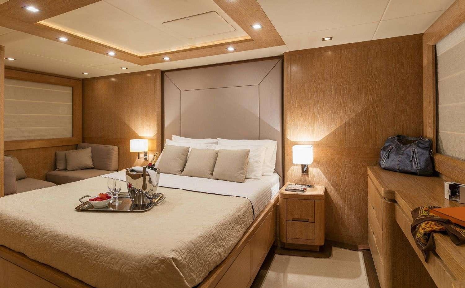 a hotel room with a bed and a couch aboard MYTHOS Yacht for Charter
