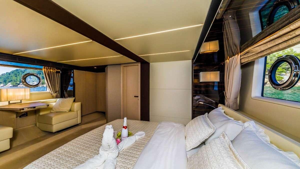 a room with a bed and a table aboard KARAT II Yacht for Charter