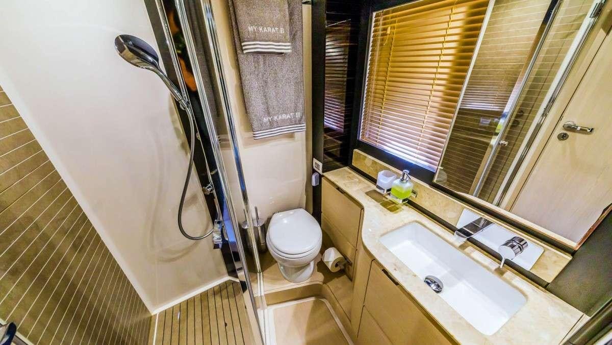 a bathroom with a shower curtain aboard KARAT II Yacht for Charter