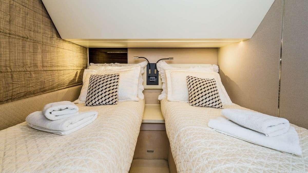 a hotel room with two beds aboard KARAT II Yacht for Charter
