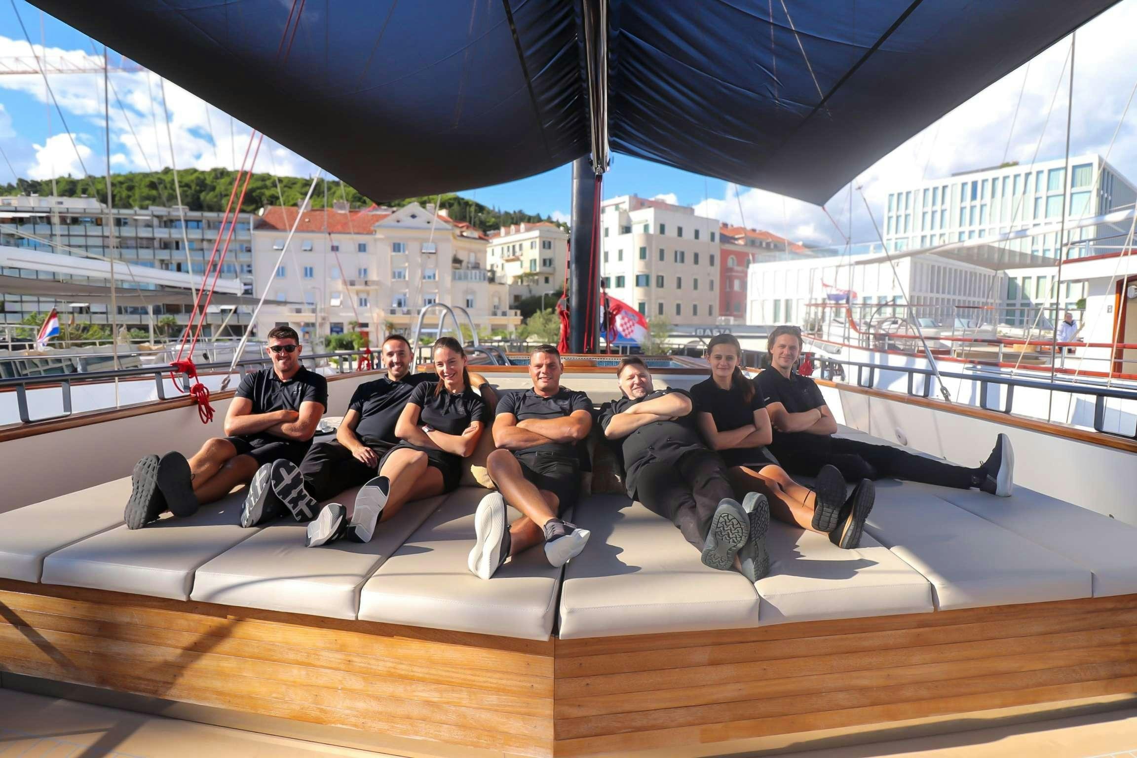 a group of people sitting on a boat aboard ANETTA Yacht for Charter