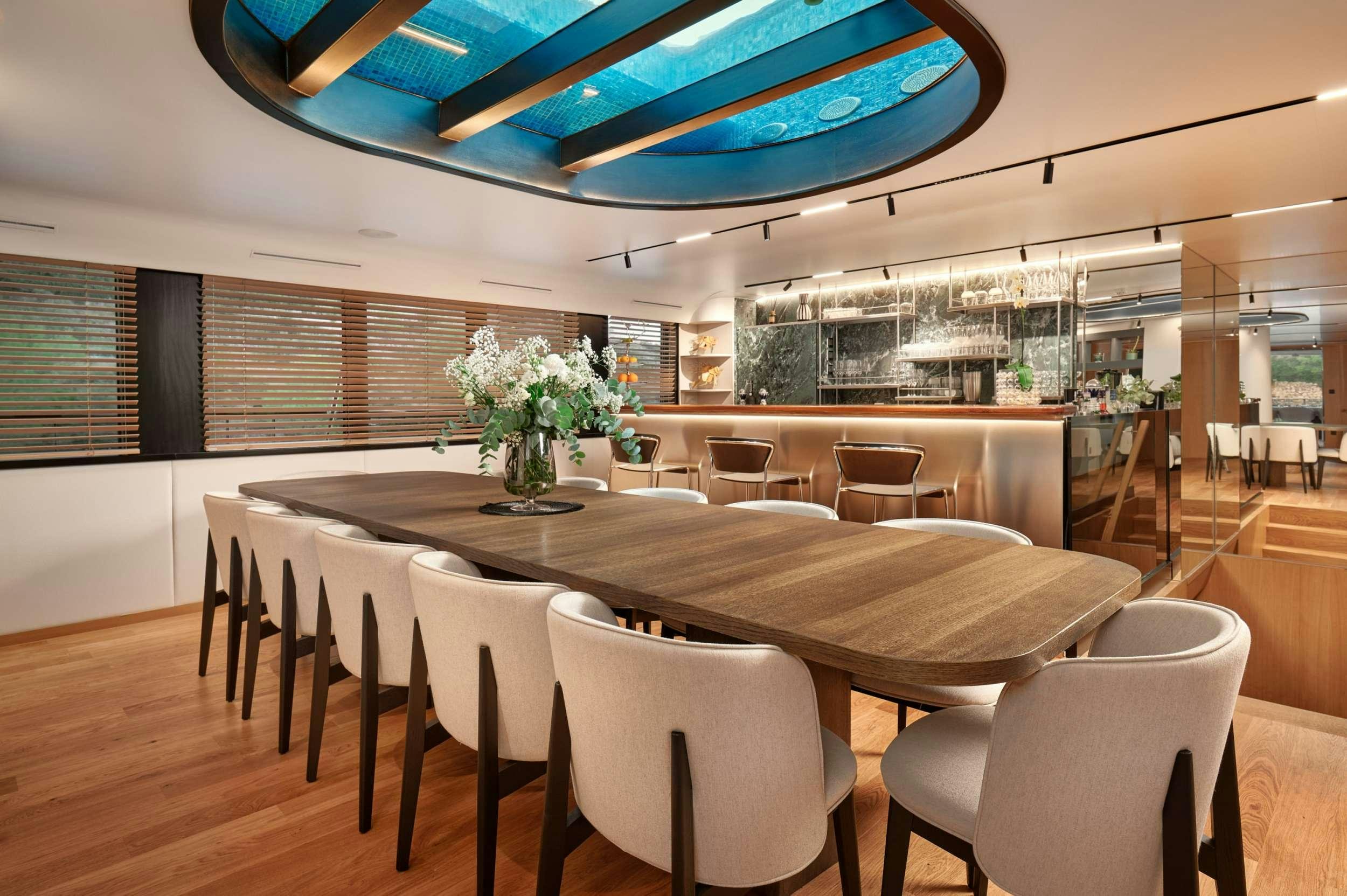 a large dining room with a large table and chairs aboard ANETTA Yacht for Charter
