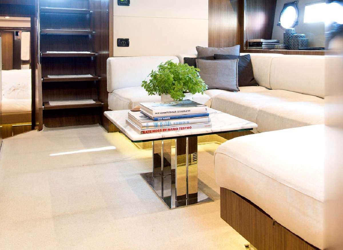 a living room with a couch and coffee table aboard W Yacht for Charter