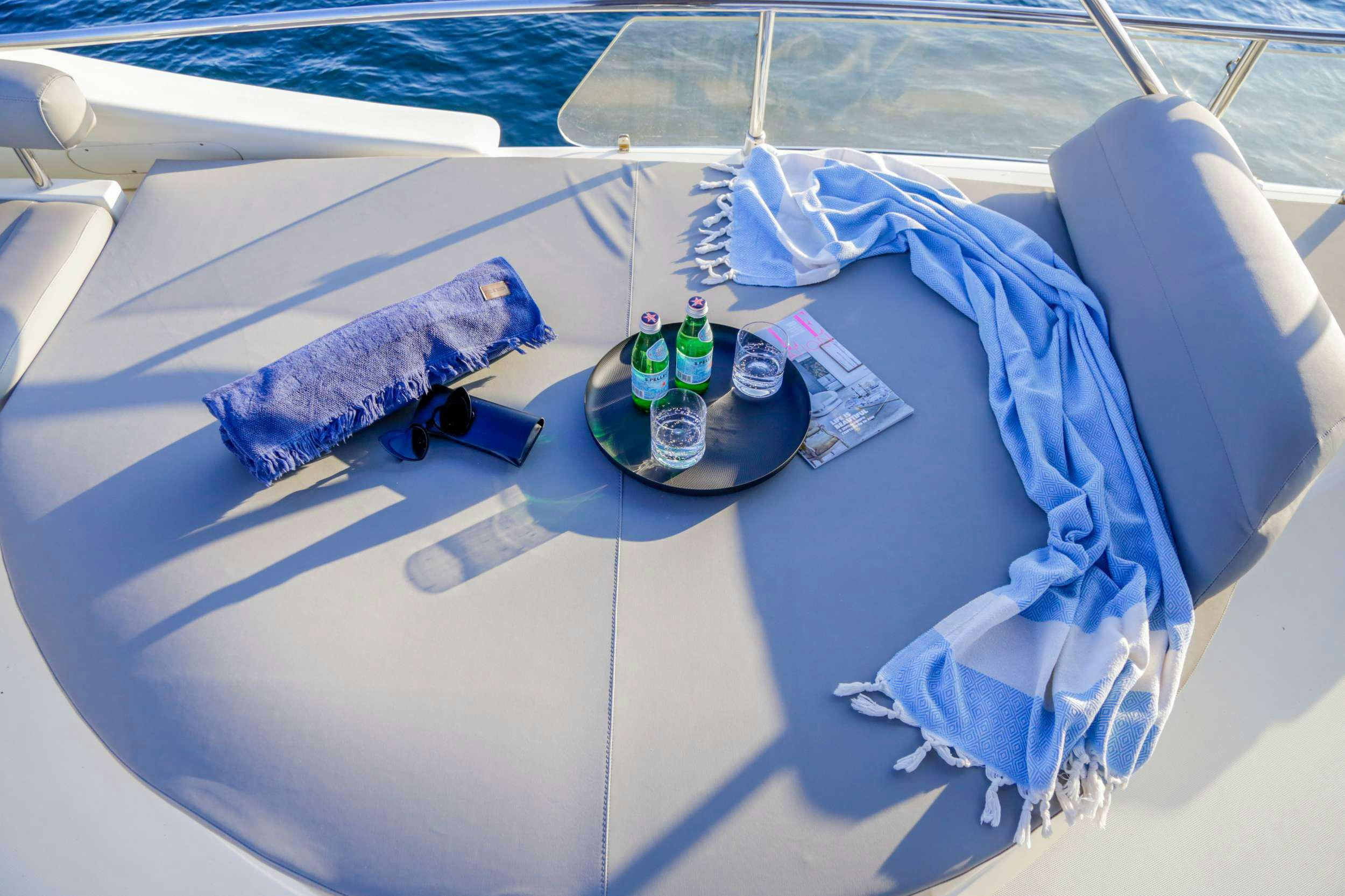 a bottle of beer and a fish on a beach aboard SUMMER CAMP Yacht for Charter