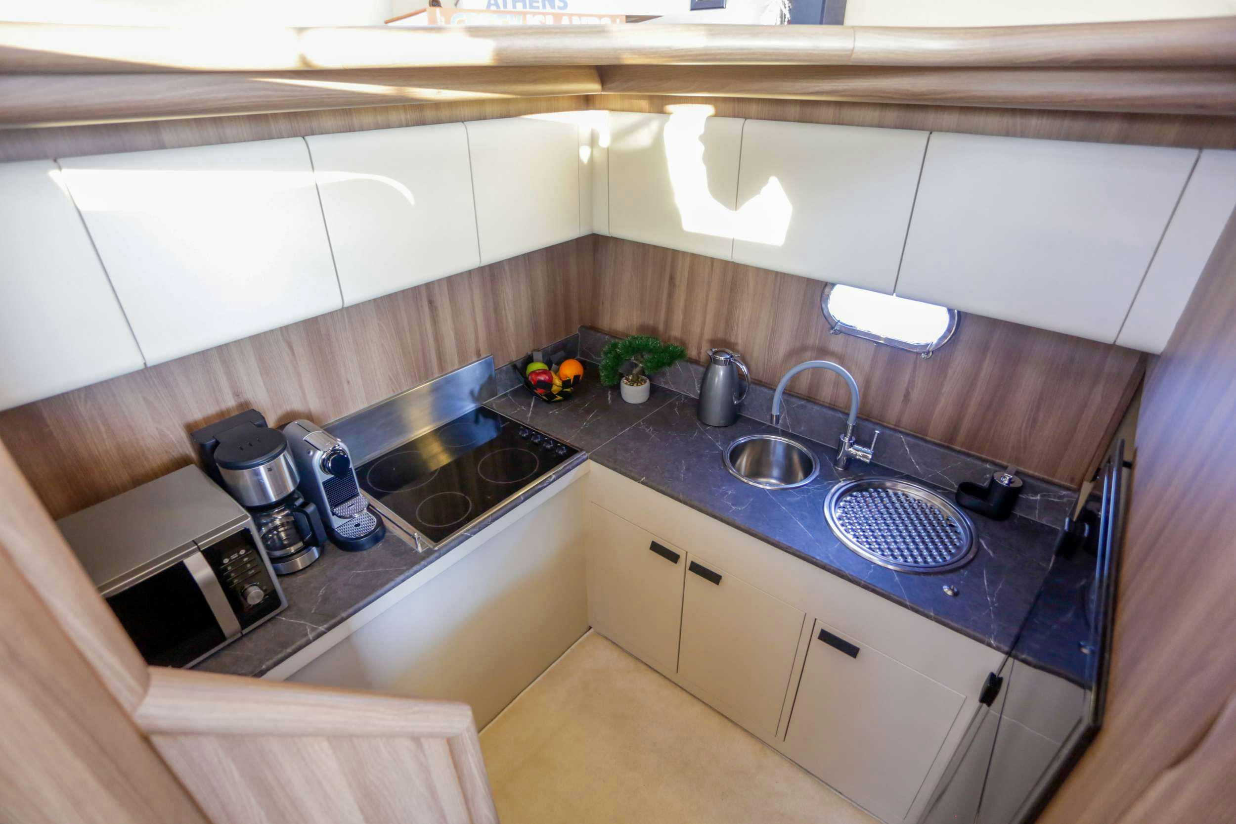 a kitchen with white cabinets aboard SUMMER CAMP Yacht for Charter